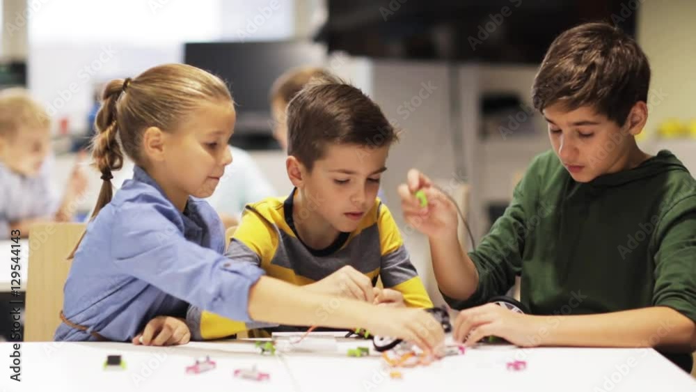 happy children making high five at robotics school happy children making high five at robotics school