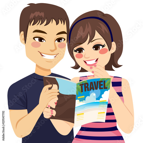 Young couple reading travel magazine planning vacation