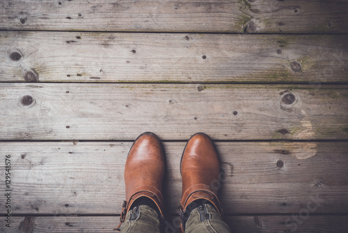 Woman in winter shoes standing on wooden floor