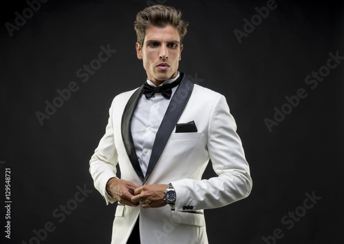 Fototapeta Wedding, Elegant and handsome man dressed in tuxedo for New Year