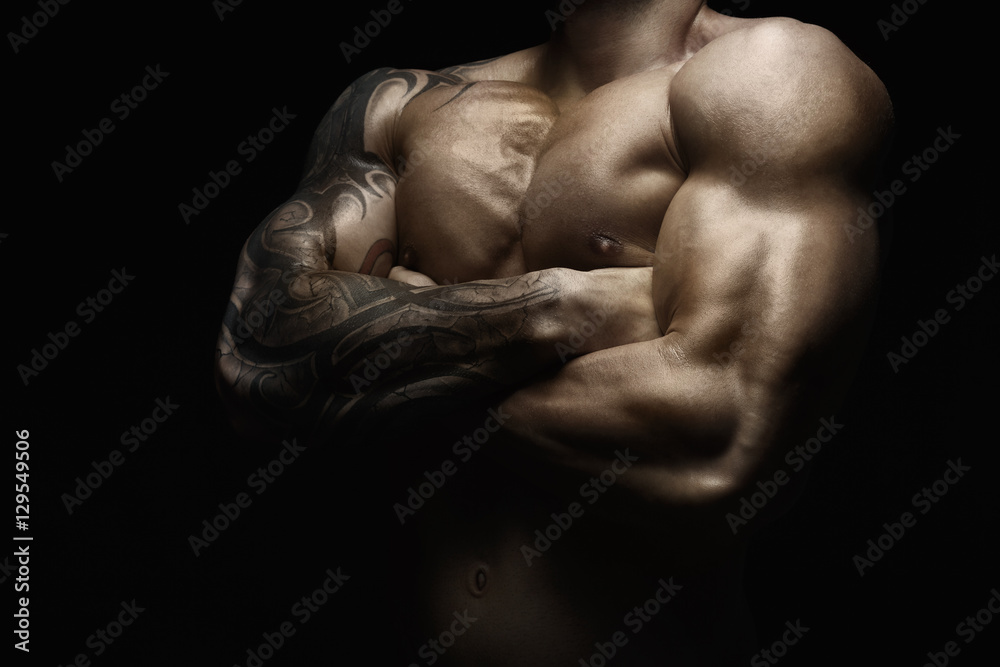 Strong athletic man showes naked muscular body Strong athletic man showes naked muscular body