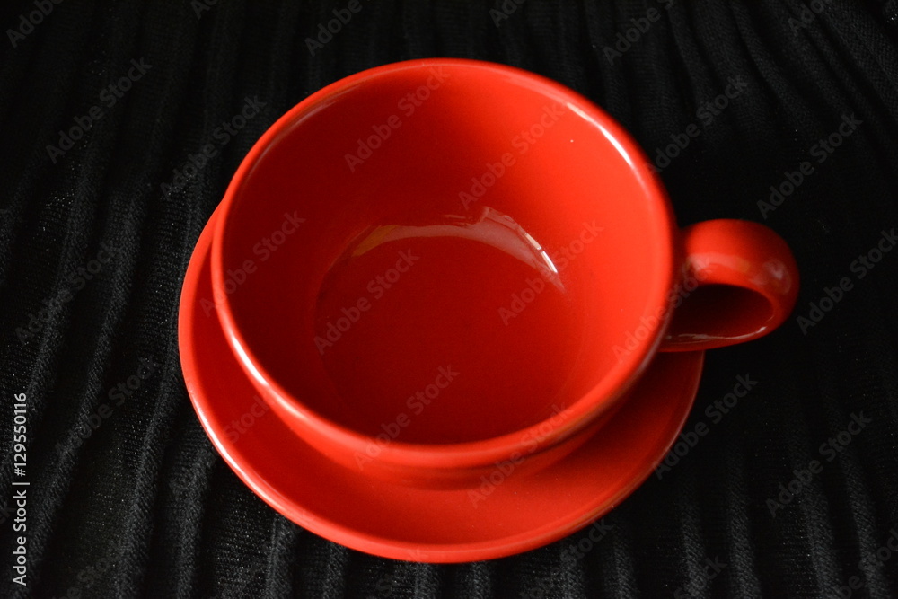 beautiful red cup, cup and saucer on a black background, coffee, tea steam, tableware, serving