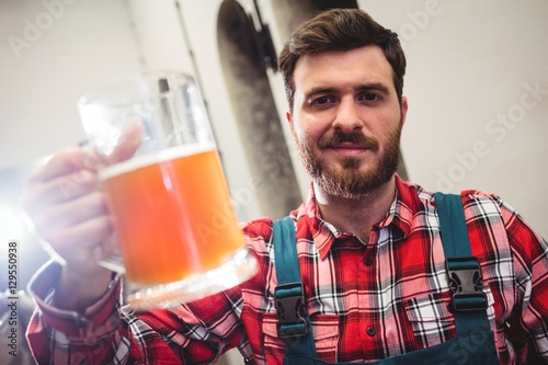 Portrait of manufacturer holding beer jug