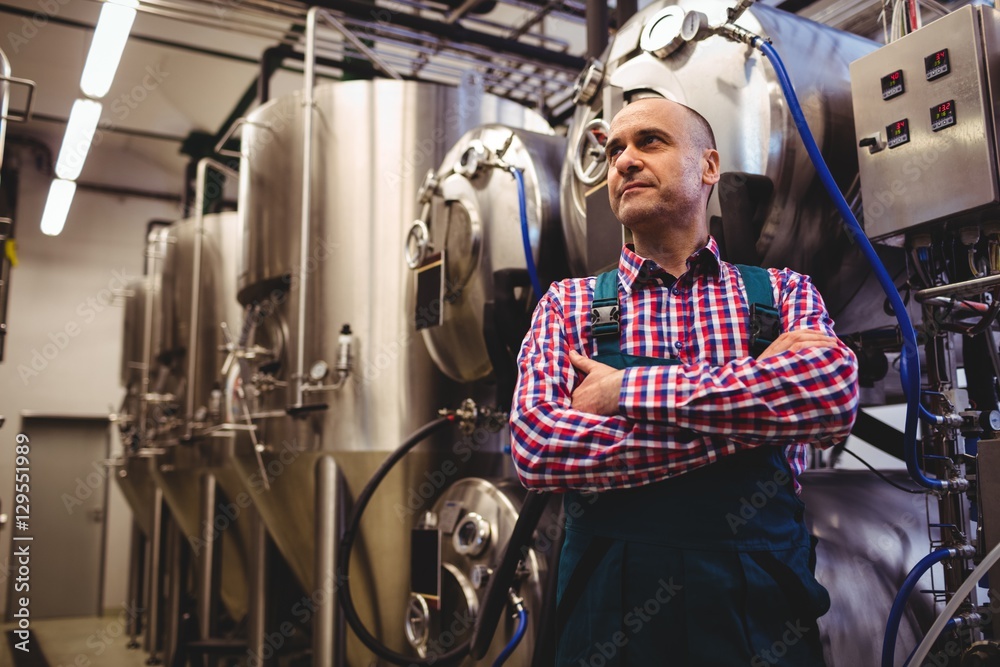 Brewery manufacturer standing by storage tank Brewery manufacturer standing by storage tank