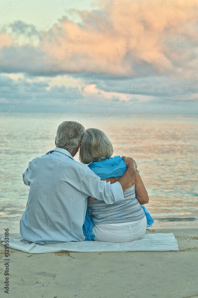 elderly couple rest at tropical beach