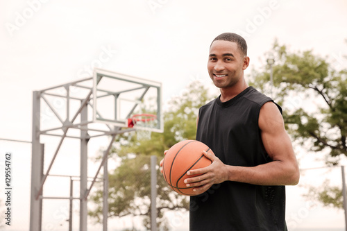 Cheerful basketball player standing in the street © Drobot Dean