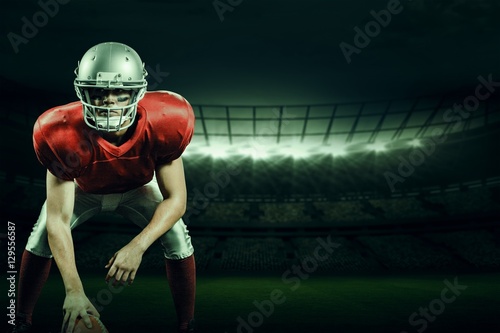 Composite image of american football player holding helmet