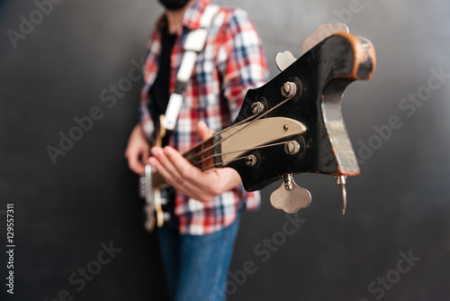 Cropped image of young man playing on the guitar © Drobot Dean