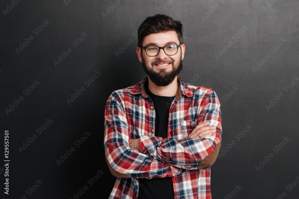 Happy man standing over chalkboard with arms crossed Happy man standing over chalkboard with arms crossed