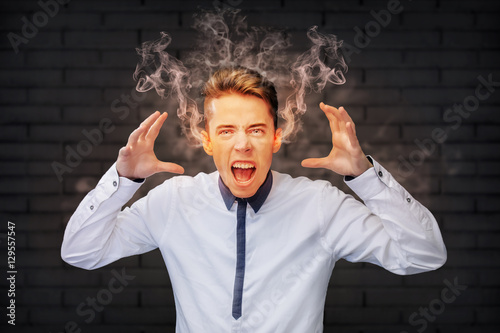 Angry man screaming with smoke coming out of his ears