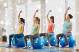 happy pregnant women with exercise balls in gym