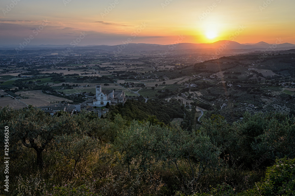 Assisi (Umbria) scenic panorama with Basilica di San Francesco at sunset