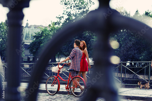 Photography Couple in Red Walking on the Street with Bike in old town in Pra