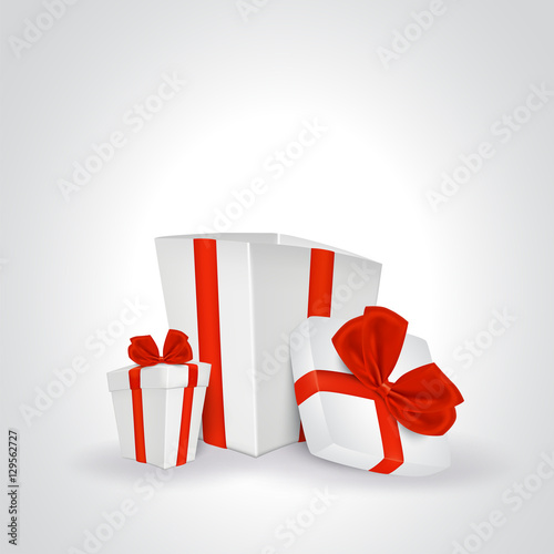 Two white gift boxes with red ribbon.