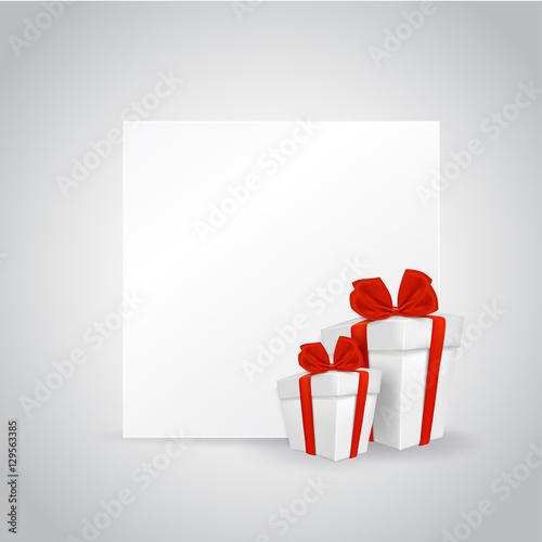 Two gift boxes with green ribbon and blank square paper.