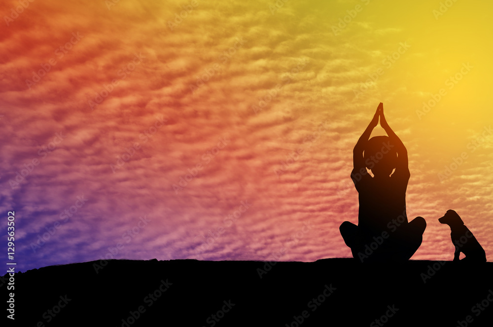 Silhouette children girl playing yoga on sky sunset background.