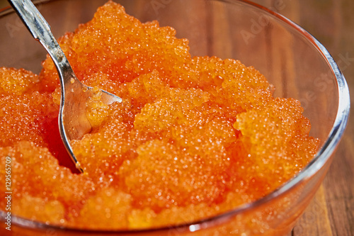 Glass cup with red caviar