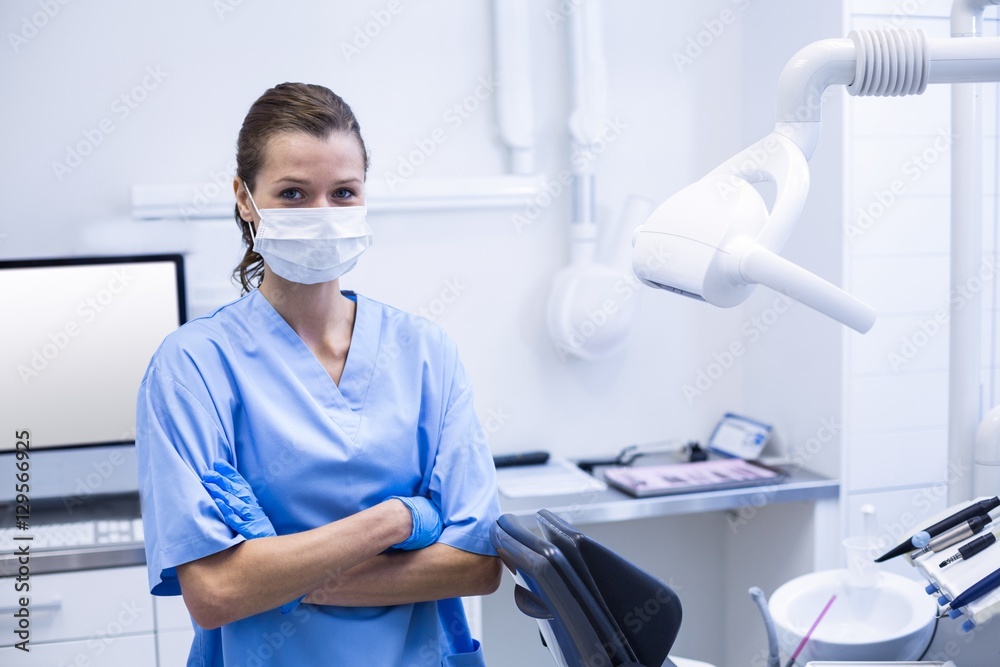 Smiling dental assistant standing with arms crossed Smiling dental assistant standing with arms crossed