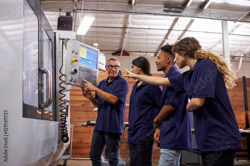 Engineer Training Apprentices On CNC Machine © Monkey Business