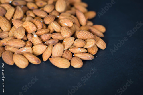 close up almonds nuts on black background