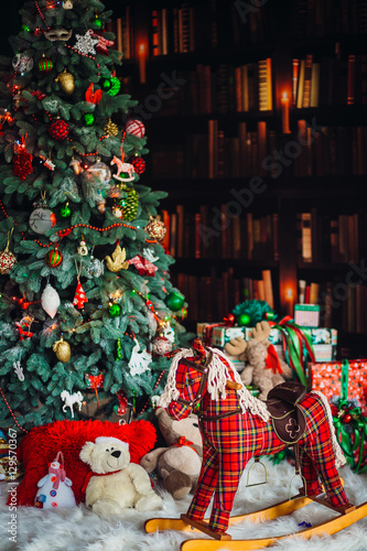 The Christmass tree stands near hobbyhorse