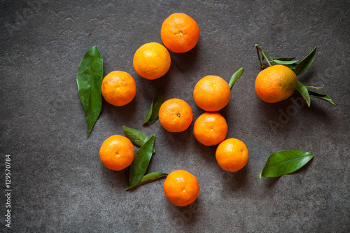 Fresh tangerines with leaves © George Dolgikh
