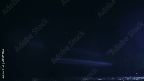 Beautiful night snowfall and light from the car headlights. Winter landscape photo