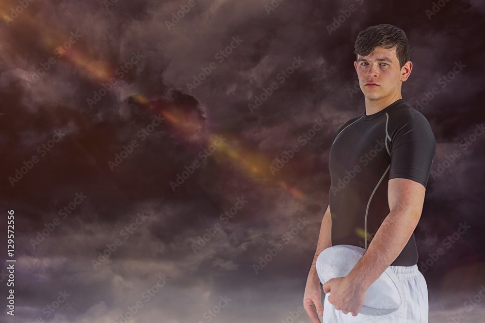Obraz premium Composite image of rugby player holding a rugby ball