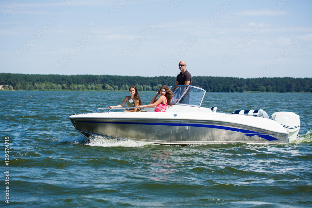 Fototapeta premium Girls ride on the boat to drift