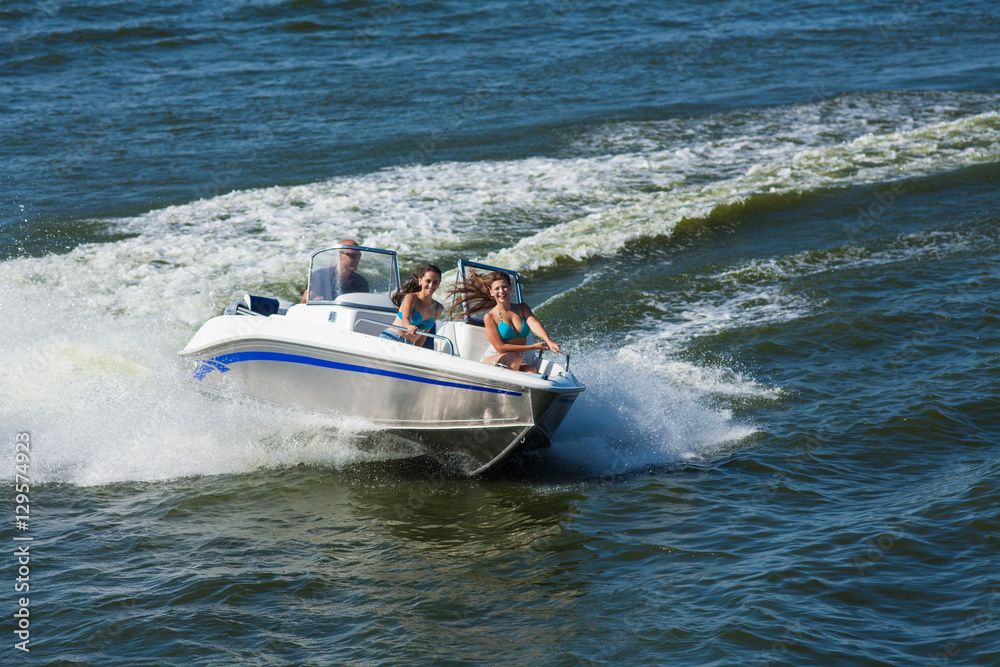 Fototapeta premium Girls ride on the boat to drift