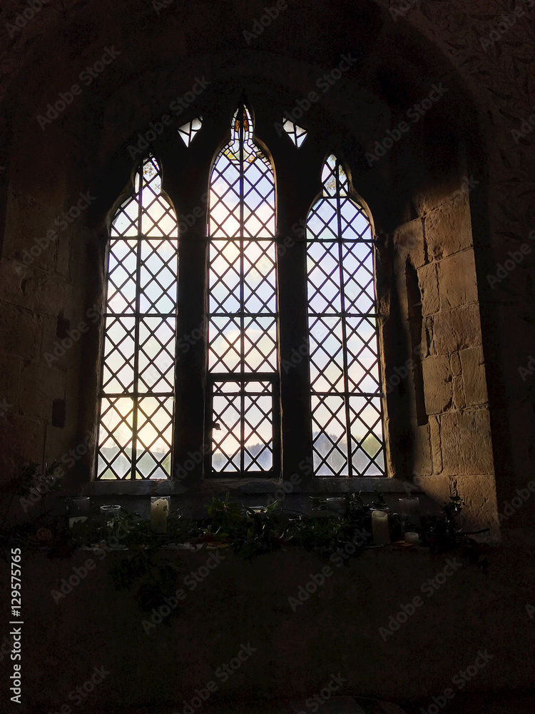 BAKEWELL, ENGLAND - DECEMBER 4: Interior view of a window at the chapel at Haddon Hall in Derbyshire, England. In Bakewell, Derbyshire, England. On 4th December 2016.