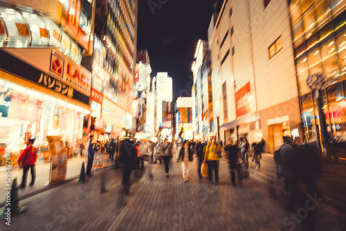Tableau sur toile blur crowds moving on a major shopping area for electronic, computer, anime, games and manga (otaku) goods in  Akihabara, Tokyo, Japan