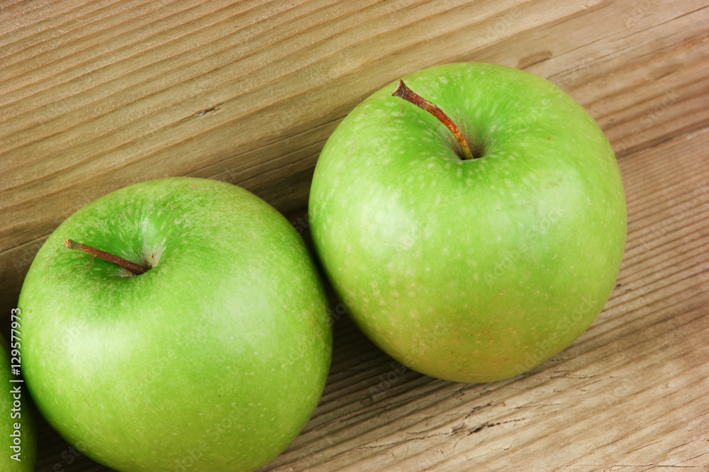 green apples on a wooden background green apples on a wooden background