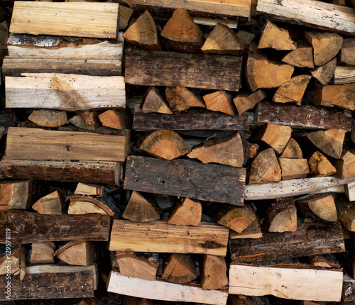 Dry Firewood neatly stacked in the woodpile. Background.