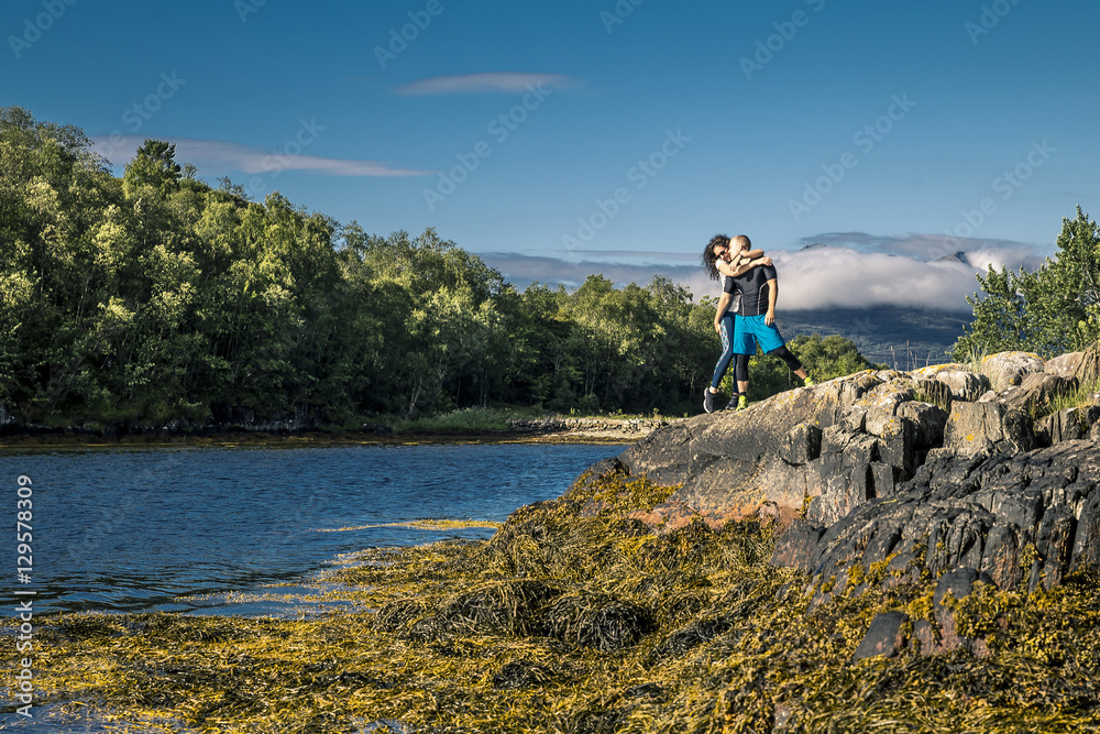 Happy and sporty couple enjoying the sunny day in Norway