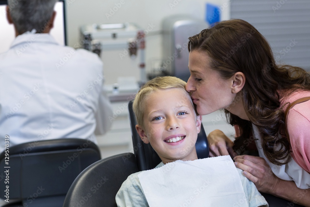 Mother kissing her son while dental examination Mother kissing her son while dental examination