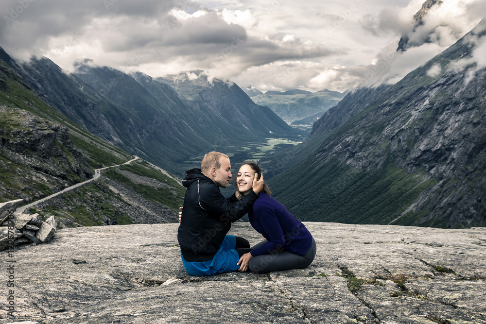 Young couple hiking in Trollstigen, Norway