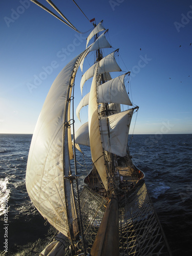 full sails of a traditional tallship or squarerigger at sea, from bowsprit