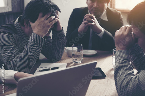 Φωτογραφία Team of unhappy businesspeople sitting in business meeting./stra