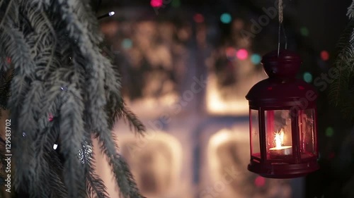 Lantern on a background of snow-covered window with Christmas lights