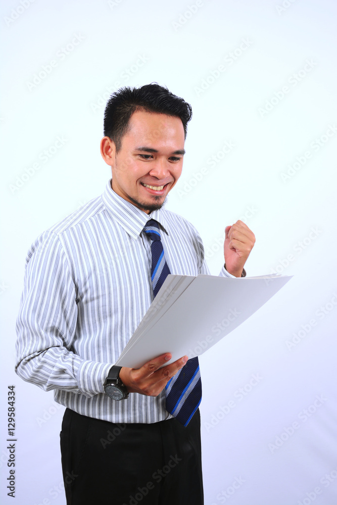 succesful asian bussinessman, very happy look at the white paper succesful asian bussinessman, very happy look at the white paper