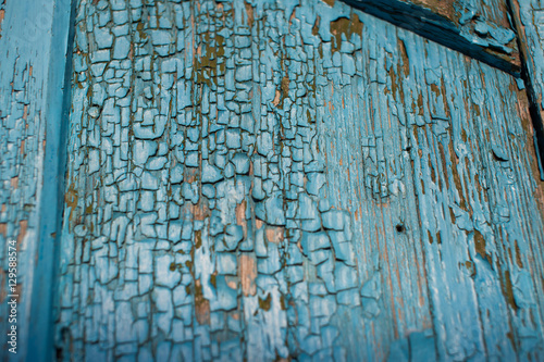 Old and peeled creaky paint , In course of time the paint of white tone peeled off the old planks and crackled, wood texture, background, colorful, cracks in the paint, vintage, abstract, grunge,