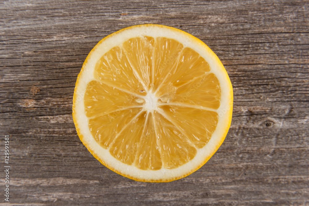 Half of lemon on gray board/Close up of lemon