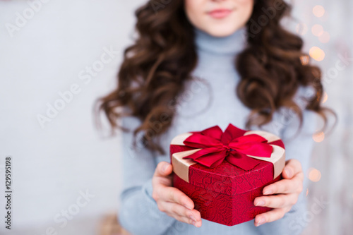 Girl holds a gift for the holiday.