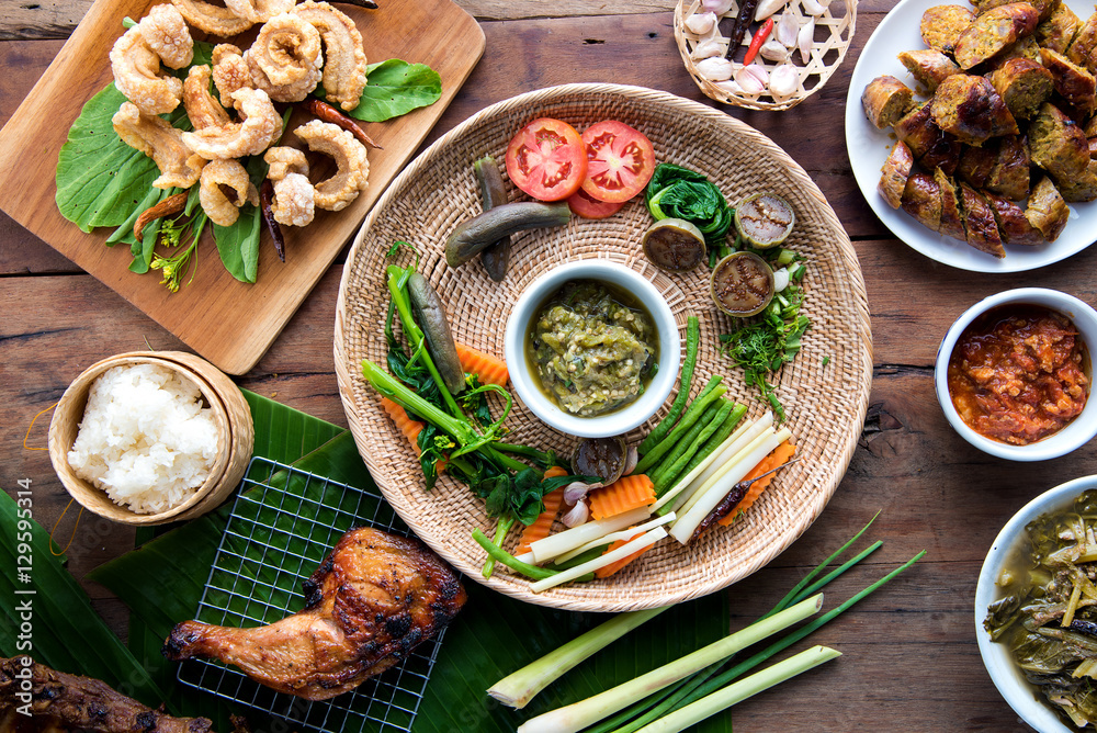 Tradition Northern Thai food. Thai cuisine nam prik or chili sauce, Thai sausages , deep fried pork skin. Thai food concept Tradition Northern Thai food. Thai cuisine nam prik or chili sauce, Thai sausages , deep fried pork skin. Thai food concept