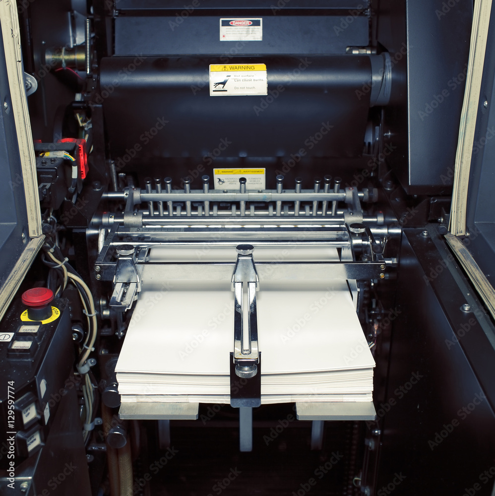 Fragment of digital offset machine with paper ready for printing Fragment of digital offset machine with paper ready for printing