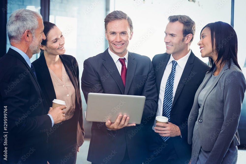 Business people standing together with laptop Business people standing together with laptop