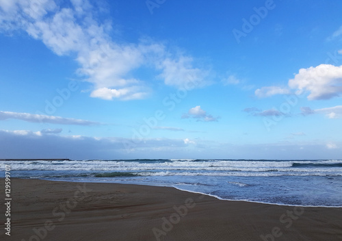 Deserted beach near the blue sea