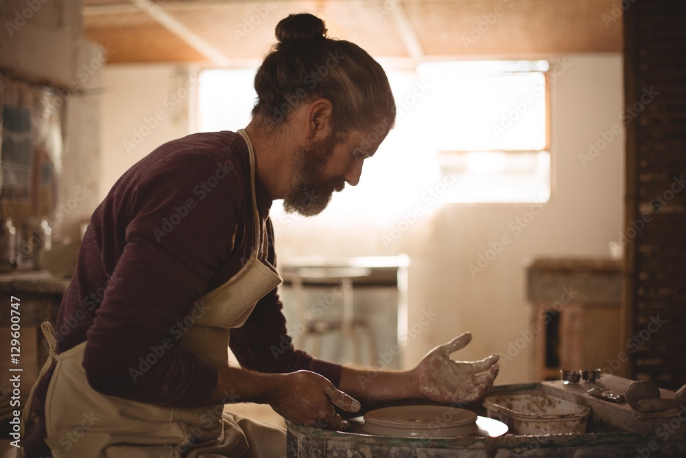 Male potter making a pot Male potter making a pot