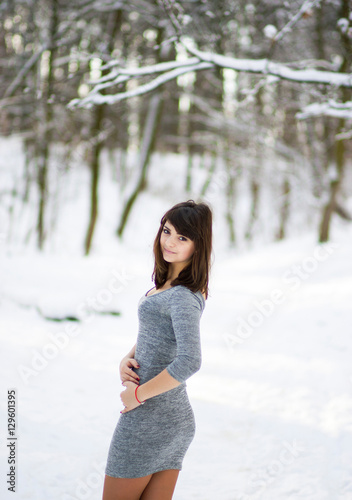 Sexy girl in a gray dress standing in the winter park © Yuliia